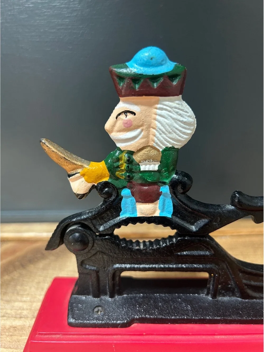 Vintage Cast Iron Nutcracker with Colorful King Figure on Red Base 7x5in.